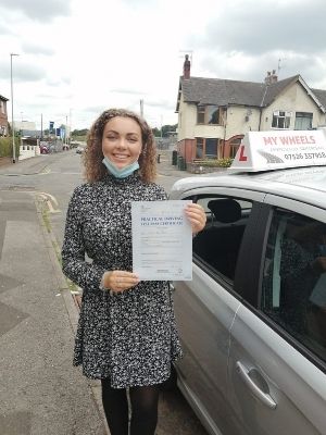 connie holding a driving pass certificate